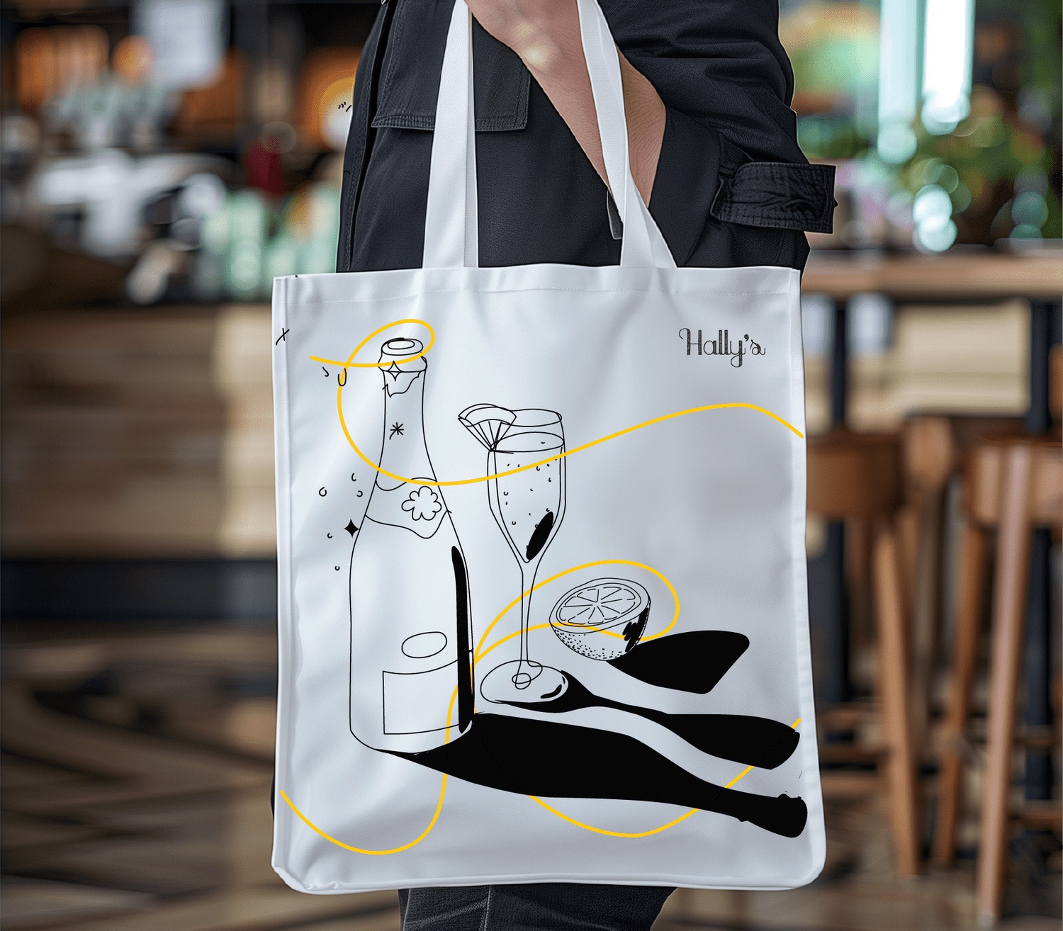 Hally's tote bag, printed with the champagne illustration and wandering line