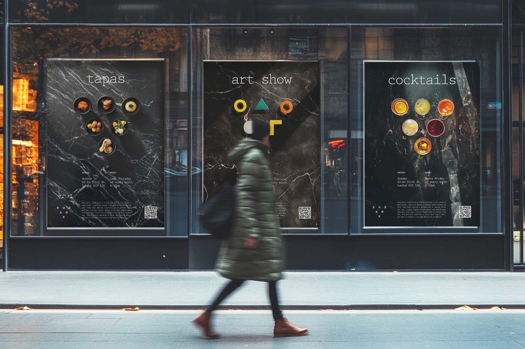 Sussex event posters displayed on a wall, with a passer-by walking in front