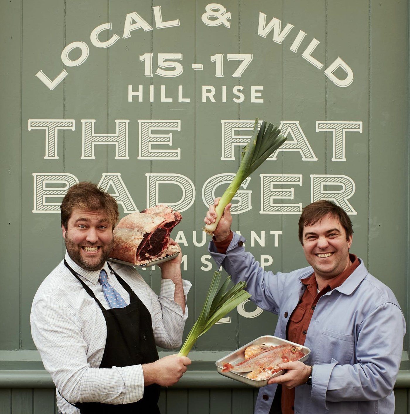 The Gladwin Brothers in front of The Fat Badger sign